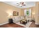 Relaxing living room with a plush sofa, decorative pillows, and a view of the well-lit window at 2417 Passamonte Dr # 1E, Winter Park, FL 32792
