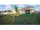 Expansive backyard with lush lawn, patio, fire pit, and privacy fence, perfect for outdoor living at 5189 Greenheart Ave, Mount Dora, FL 32757