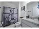 Full bathroom features a granite vanity, toilet, and shower with fun curtain at 5189 Greenheart Ave, Mount Dora, FL 32757