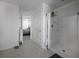 Bright bathroom featuring a shower with white tile and a clear glass enclosure at 5189 Greenheart Ave, Mount Dora, FL 32757