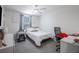 This cozy bedroom includes a ceiling fan, a window, and a pet crate at 5189 Greenheart Ave, Mount Dora, FL 32757