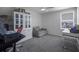 Spacious bedroom with a comfortable gray sofa, desk, and well-lit window at 5189 Greenheart Ave, Mount Dora, FL 32757