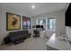 Bedroom featuring two windows, tile floors, decorative posters, and a gray futon at 5189 Greenheart Ave, Mount Dora, FL 32757