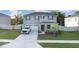 Exterior view showcasing the home's well-kept lawn, modern design, and inviting curb appeal at 5189 Greenheart Ave, Mount Dora, FL 32757