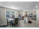 Open kitchen and dining area with tile flooring, and modern appliances at 5189 Greenheart Ave, Mount Dora, FL 32757