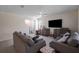 Spacious living room featuring comfortable couches, tile floors, and plenty of natural light at 5189 Greenheart Ave, Mount Dora, FL 32757