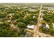 Scenic aerial view of the area showcasing lush greenery, homes, and a connecting road at 808 S Clara Ave, Deland, FL 32720
