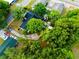 An aerial view of a lovely home surrounded by lush trees, multiple cars in the driveway, and a backyard shed at 808 S Clara Ave, Deland, FL 32720