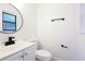 Well-lit bathroom featuring black fixtures and a round mirror at 808 S Clara Ave, Deland, FL 32720