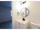 Updated bathroom featuring a modern vanity with black fixtures and a round mirror at 808 S Clara Ave, Deland, FL 32720