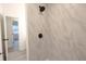 Shower with light marble patterned tile and black hardware at 808 S Clara Ave, Deland, FL 32720