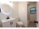 Bright bathroom with modern vanity, illuminated mirror, and tiled walk-in shower at 808 S Clara Ave, Deland, FL 32720