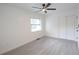 Bedroom featuring gray flooring, ceiling fan, and window at 808 S Clara Ave, Deland, FL 32720