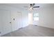 Light bedroom with gray floors, ceiling fan, and two door types at 808 S Clara Ave, Deland, FL 32720