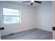 Neutral bedroom featuring large window for natural light, and wood look floors at 808 S Clara Ave, Deland, FL 32720