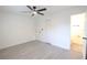 Bedroom with gray flooring, ceiling fan, and open door to bathroom at 808 S Clara Ave, Deland, FL 32720