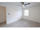 Bright bedroom with neutral walls, gray floors, and ceiling fan at 808 S Clara Ave, Deland, FL 32720