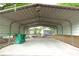 Carport with a green yard tool caddy and a detached storage unit in the backyard at 808 S Clara Ave, Deland, FL 32720
