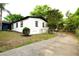 Exterior side view of a freshly painted home with a blue front door at 808 S Clara Ave, Deland, FL 32720
