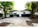 An exterior view of a charming home with two tone paint, a patio and trees at 808 S Clara Ave, Deland, FL 32720