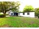Charming home featuring a lush green lawn and mature trees, offering a serene and inviting curb appeal at 808 S Clara Ave, Deland, FL 32720