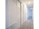 Hallway with grey wood-look flooring and white doors on both sides at 808 S Clara Ave, Deland, FL 32720