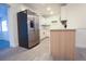 Open kitchen showcasing stainless steel refrigerator and an open floor plan with light colored floors at 808 S Clara Ave, Deland, FL 32720