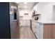 Spacious kitchen featuring white cabinets, stainless steel appliances and stylish butcher block accent at 808 S Clara Ave, Deland, FL 32720
