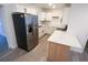Modern kitchen featuring stainless steel refrigerator and new white cabinets with black hardware at 808 S Clara Ave, Deland, FL 32720
