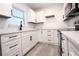 Bright kitchen features white cabinets, modern appliances, and ample counter space at 808 S Clara Ave, Deland, FL 32720