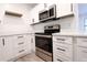Kitchen appliances include stainless steel oven, microwave, and white cabinets with dark hardware at 808 S Clara Ave, Deland, FL 32720