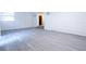 Spacious room with plank flooring; steps lead to kitchen, creating an open layout at 808 S Clara Ave, Deland, FL 32720
