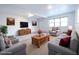 Bright, neutrally-toned living room is virtually staged with comfortable seating and decor at 808 S Clara Ave, Deland, FL 32720