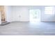 Well-lit open living space with plank floors, a large window, and an exterior entrance at 808 S Clara Ave, Deland, FL 32720