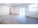 Bright, open living space features neutral plank flooring, large windows, and natural light at 808 S Clara Ave, Deland, FL 32720