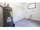 Utility room with water heater, shelving, window, and hookups at 808 S Clara Ave, Deland, FL 32720