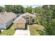 Aerial view of a well-maintained single-story home with an attached garage, driveway, and a neatly kept lawn at 1309 Timberbend Cir, Orlando, FL 32824