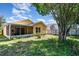 Backyard with a lawn and exterior of a home and a screened in porch at 1309 Timberbend Cir, Orlando, FL 32824