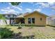 Backyard with a lawn and exterior of a home and a screened in porch at 1309 Timberbend Cir, Orlando, FL 32824