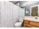 Functional bathroom featuring a shower with a curtain, toilet, sink, and vanity with storage at 1309 Timberbend Cir, Orlando, FL 32824