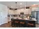 Bright kitchen with large island, pendant lighting, stainless steel appliances, and modern cabinetry at 17020 Cercis Loop, Clermont, FL 34711
