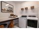 Functional laundry room with modern appliances, ample counter space, and stylish decor at 17020 Cercis Loop, Clermont, FL 34711