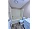 Bathroom featuring a tub with shower, white toilet, and wooden flooring at 4300 Meadow Ridge Ave, Mulberry, FL 33860