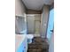 Bathroom featuring a shower stall with glass doors, white toilet, and wooden flooring at 4300 Meadow Ridge Ave, Mulberry, FL 33860