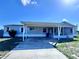 This cozy home features a screened lanai, covered carport, and established lawn at 4300 Meadow Ridge Ave, Mulberry, FL 33860