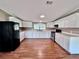 An expansive kitchen features white cabinetry, modern appliances, and lots of counter space and new vinyl floors at 4300 Meadow Ridge Ave, Mulberry, FL 33860