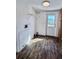 Bright laundry room with white walls, wooden floors and a utility sink at 4300 Meadow Ridge Ave, Mulberry, FL 33860