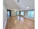 Bright and inviting, the living room features large windows, new vinyl floors and ample space for entertaining at 4300 Meadow Ridge Ave, Mulberry, FL 33860