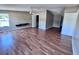 Large open living room with natural light, new vinyl floors and open doorway to hallway and bedrooms at 4300 Meadow Ridge Ave, Mulberry, FL 33860