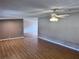 Light-filled living room featuring a ceiling fan and new vinyl floors with an open view to other rooms at 4300 Meadow Ridge Ave, Mulberry, FL 33860
